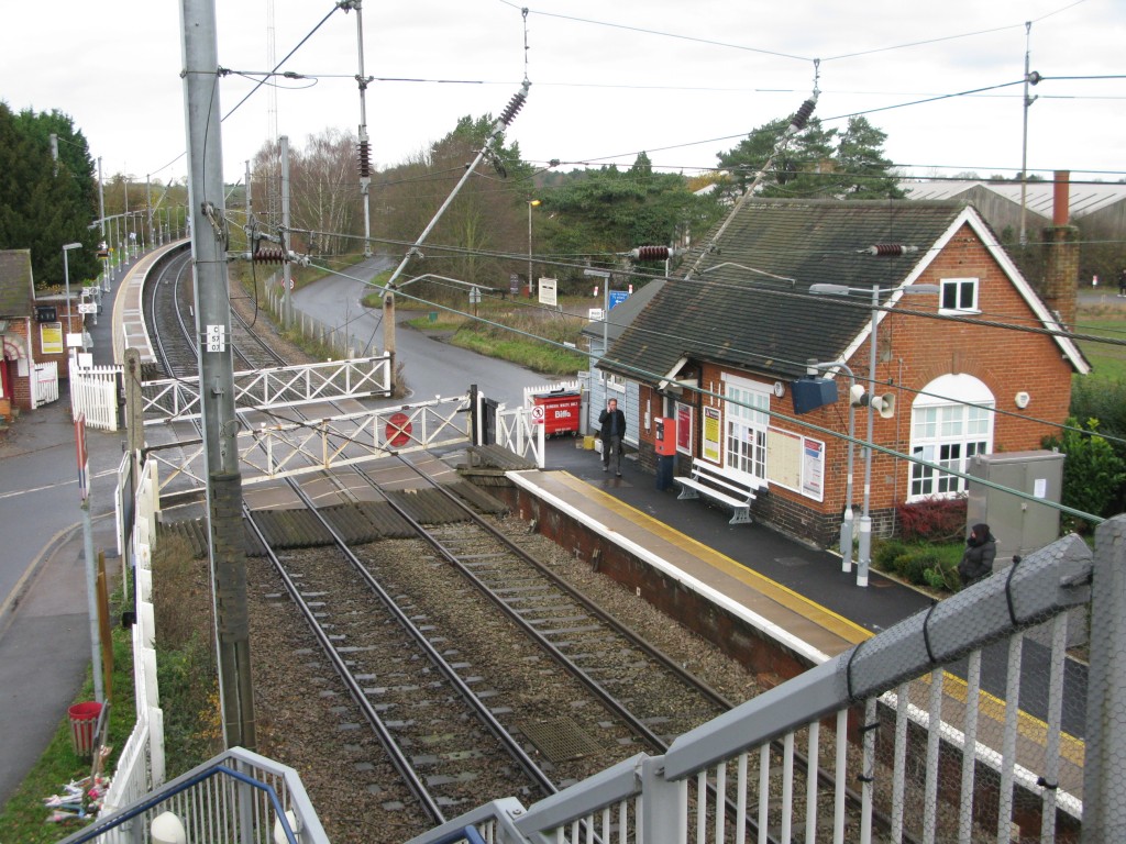 Elsenham station, December 2013, from Down side footbridge stairs. Floral tribute, bottom left. (Photo: © London Intelligence)