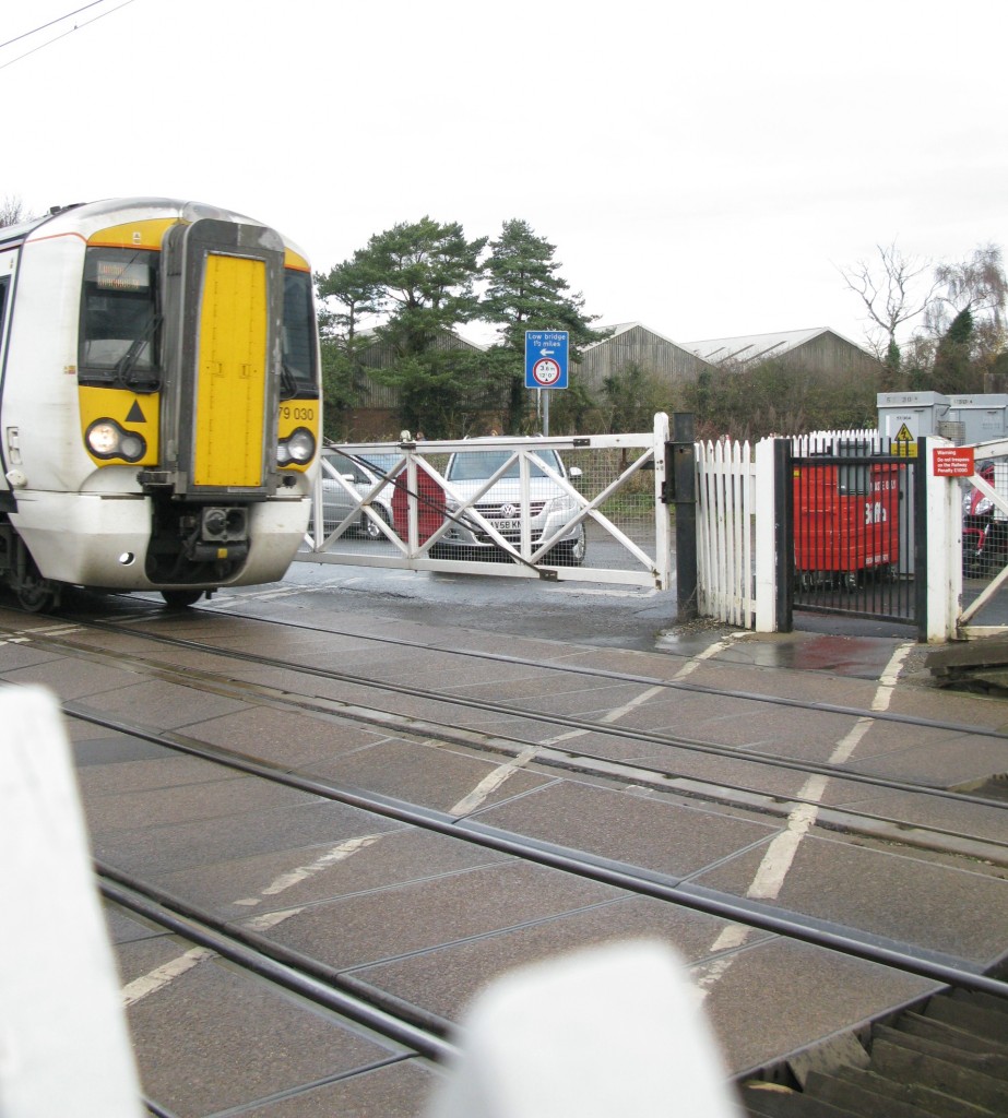 Greater Anglia 379 030 passes over the station’s road and footpath crossings (Photo: © London Intelligence)