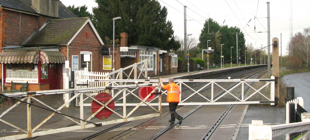 Elsenham level crossing keeper closes southern road gate to open railway (Photo: © London Intelligence)